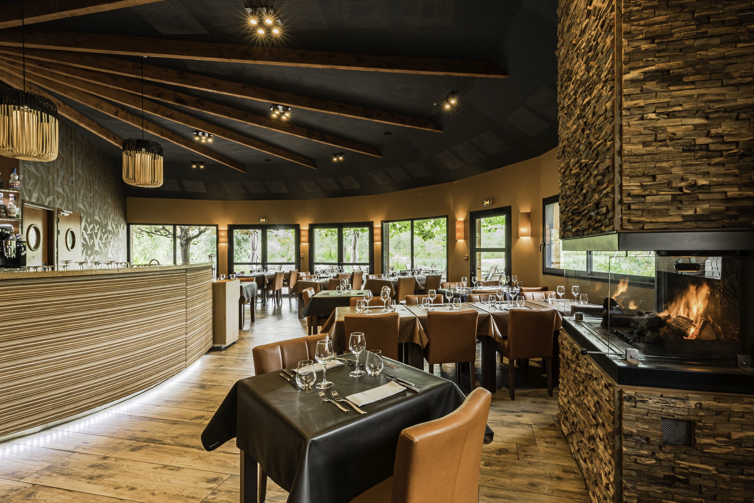 Salle du restaurant, cheminée et pierres apparentes — Les Étangs de l'Abbaye